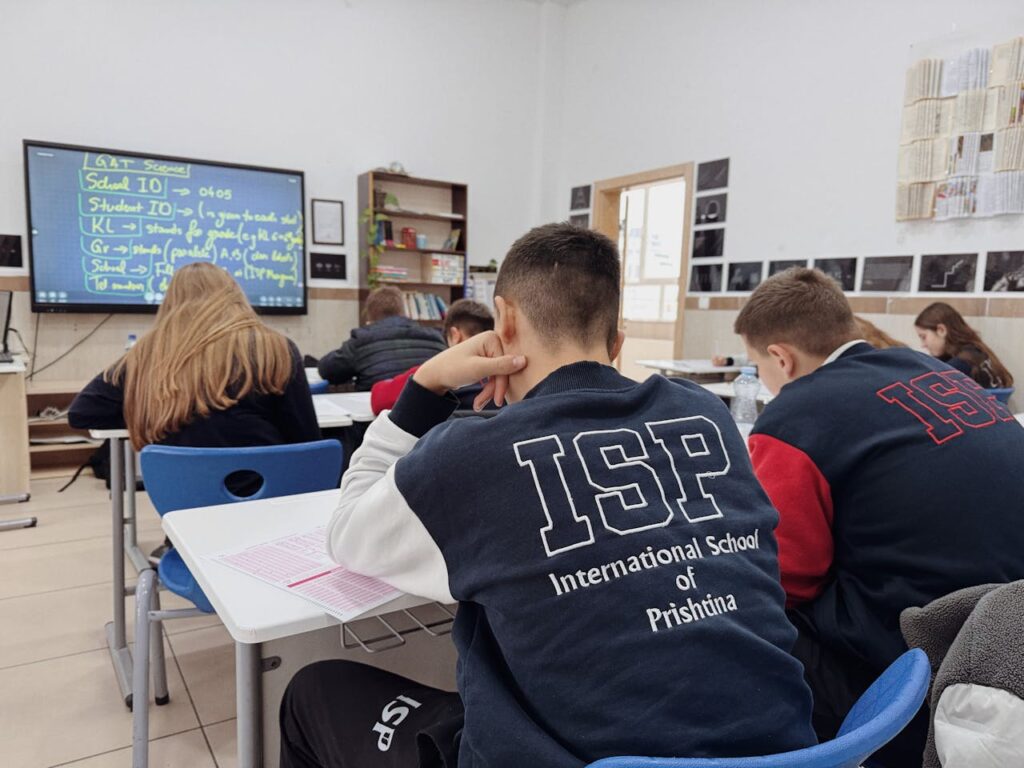 Students attentively learning in a classroom at the International School of Prishtina.